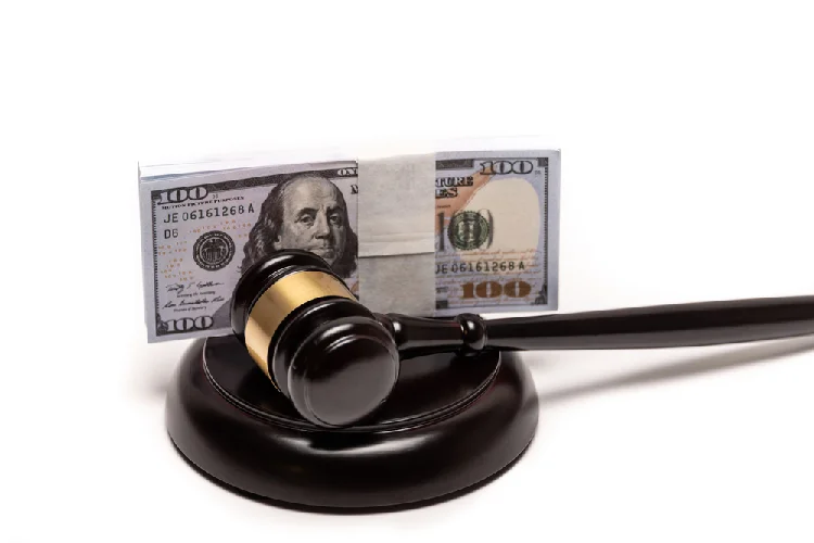 Gavel with money representing fines and penalties for failing to obtain a driveway construction permit in New Jersey