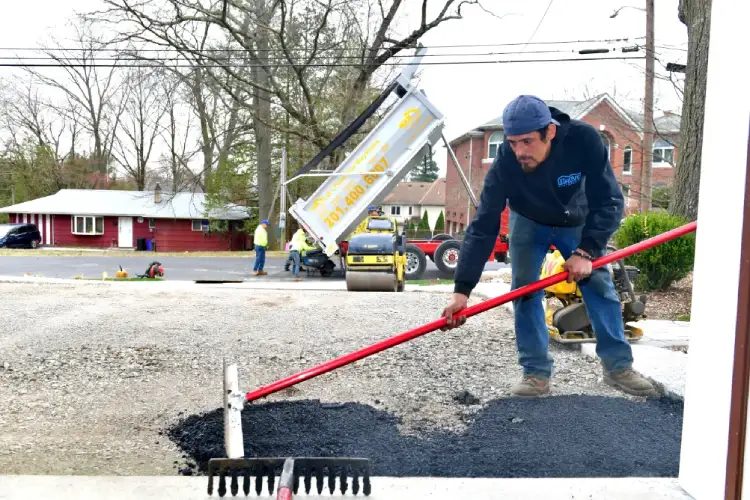 NVN Paving crew working on a driveway in Passaic County highlighting the importance of planning and scheduling paving projects with reliable contractors.