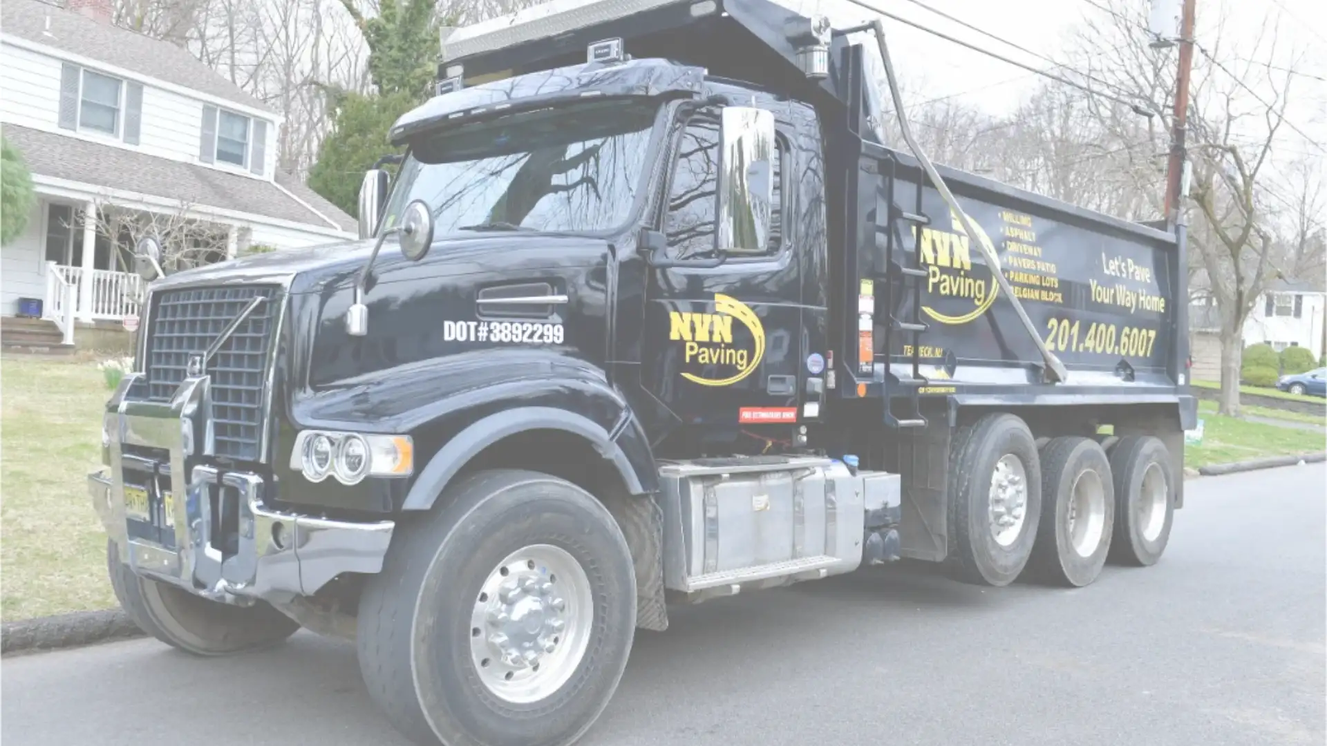 NVN Paving truck in a New Jersey neighborhood, representing licensed local paving contractors homeowners should ask about before hiring.