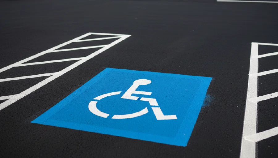 Detail of commercial parking lot paving in Somerset County, showing fresh line striping, an ADA compliant accessible parking space, and asphalt built for heavy traffic.